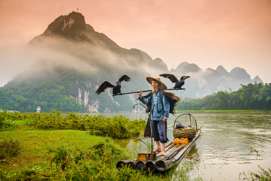 persona en el rio yangshuo, comoran